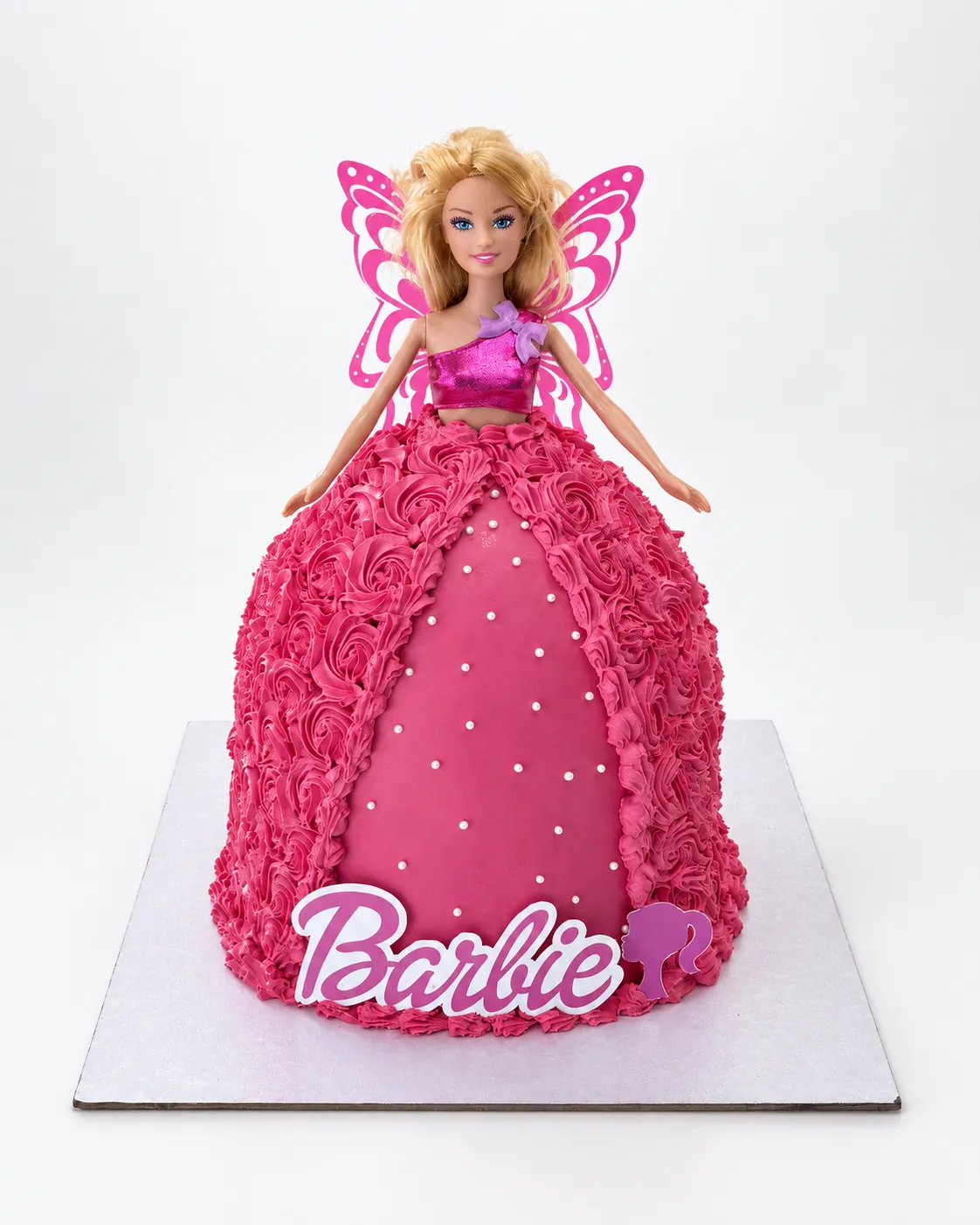 Barbie doll cake with the doll rising from a bright pink dress of piped rosettes, a smooth pink front panel with sugar pearls and a Barbie logo, a custom cake by Cakes By Vjollca in Pristina, Kosovo