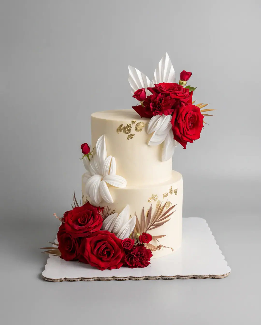 Two-tier ivory engagement cake with fresh red roses, gold leaf and white wafer paper petals, a custom cake by Cakes By Vjollca in Pristina, Kosovo