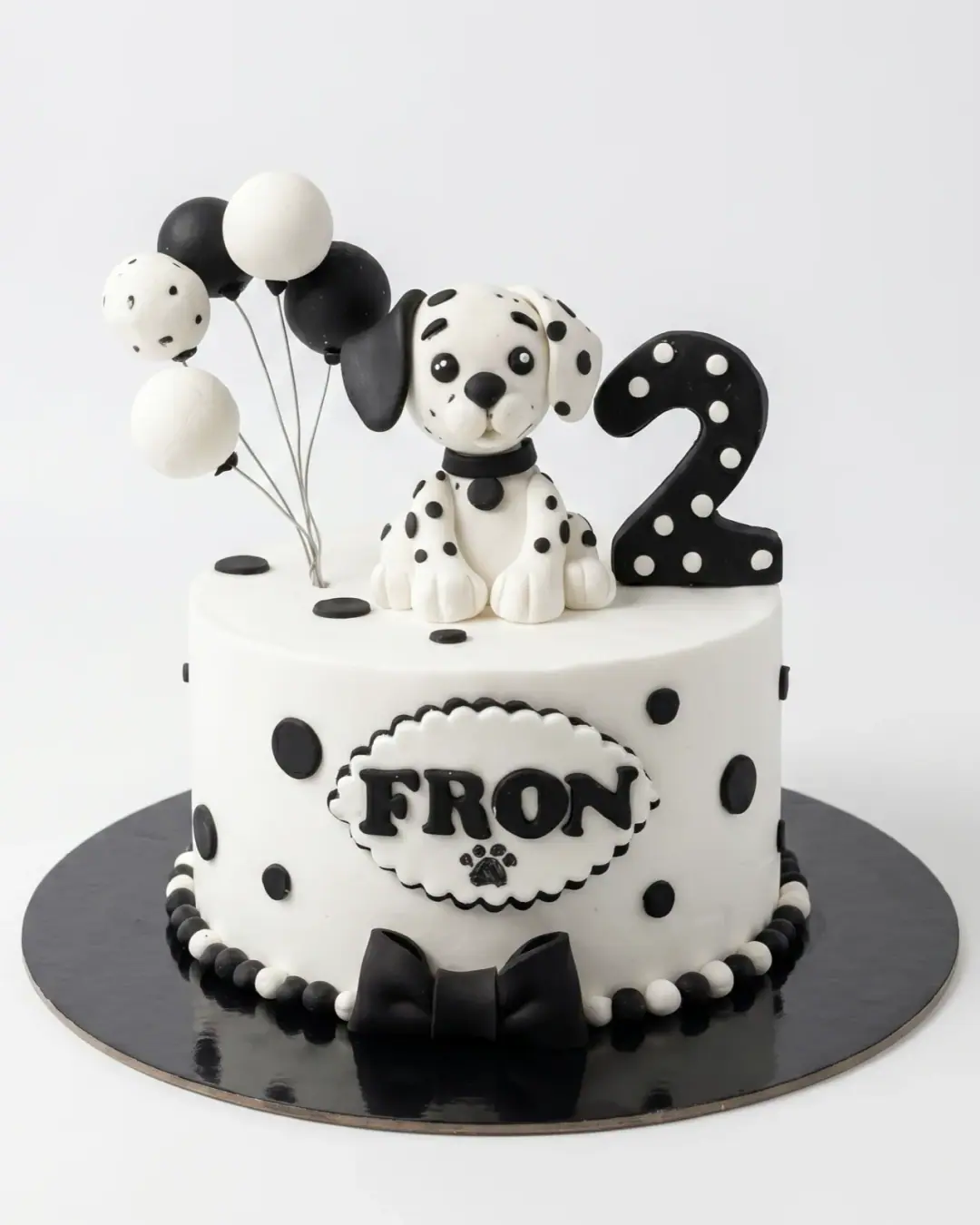 Black and white dalmatian puppy birthday cake with polka dots and balloons, a custom cake by Cakes By Vjollca in Pristina, Kosovo