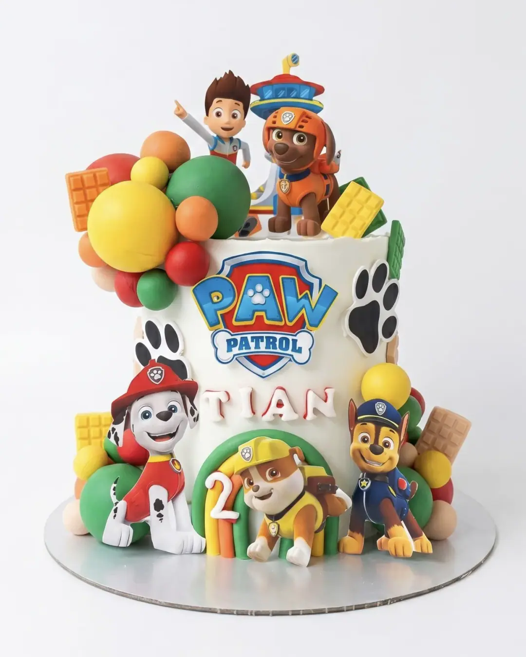 Paw Patrol birthday cake with the full crew, balloons and paw prints, a custom cake by Cakes By Vjollca in Pristina, Kosovo