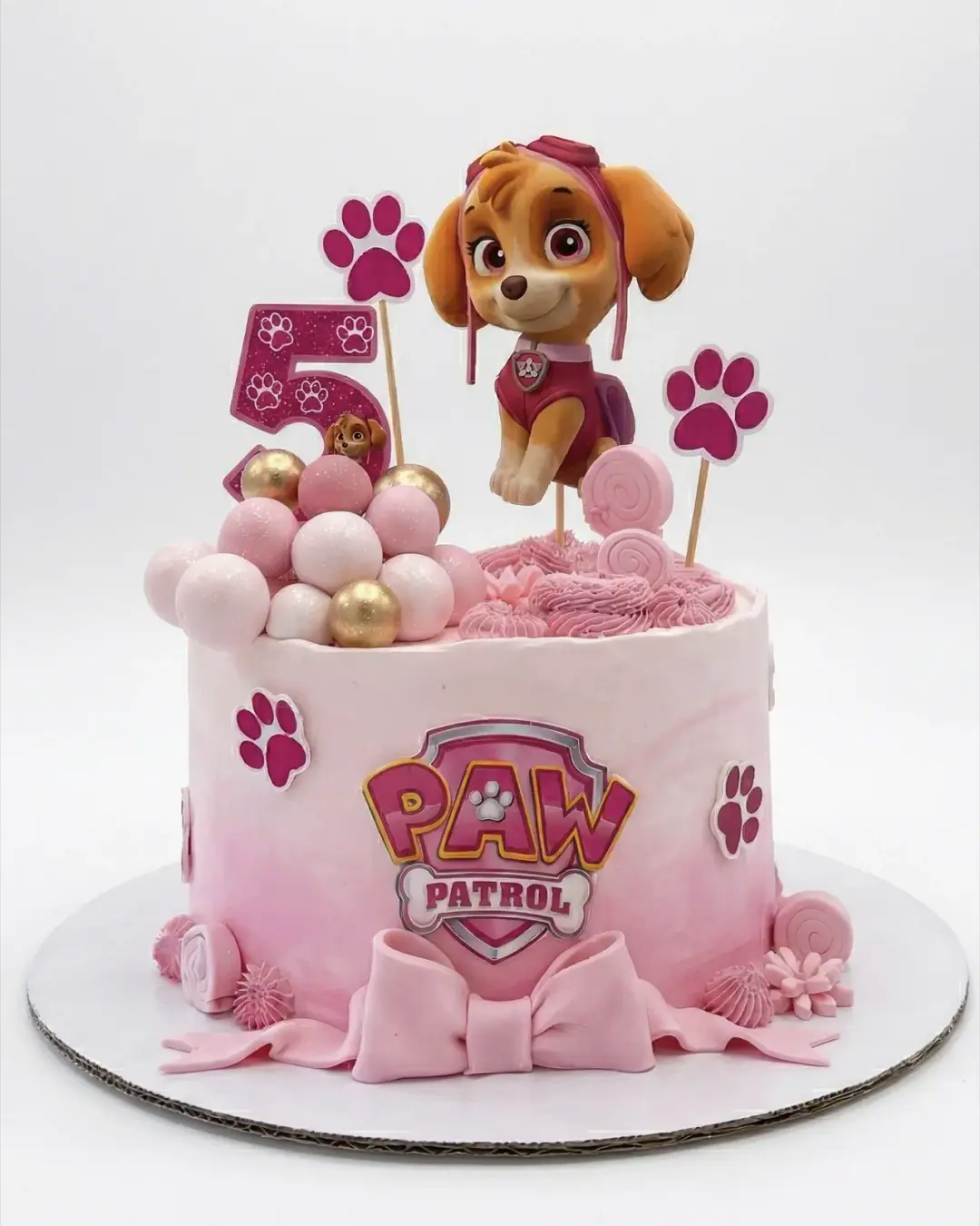 Pink Skye Paw Patrol birthday cake with paw prints and bubbles, a custom cake by Cakes By Vjollca in Pristina, Kosovo