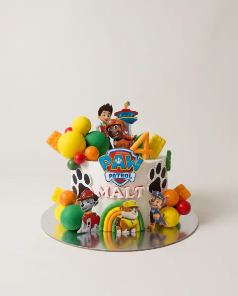 Paw Patrol birthday cake with the pups, a fondant rainbow, paw prints, candy balls, colourful sweets and the number 4, a custom cake by Cakes By Vjollca in Pristina, Kosovo